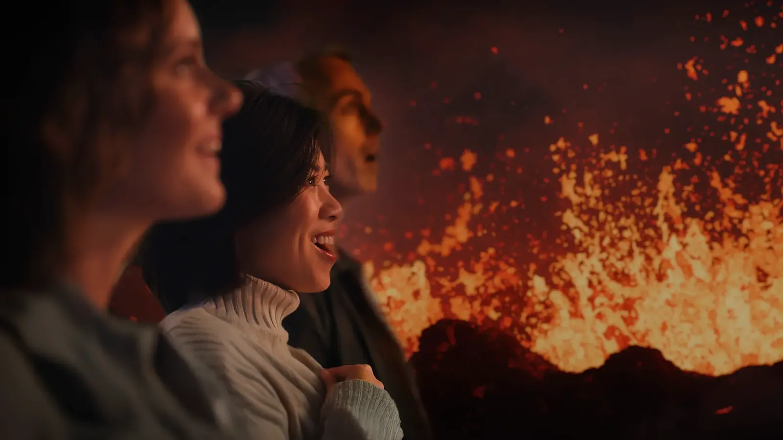Volcano Express cinematic ride at Harpa Concert Hall with audience in motion seats watching eruption footage, Reykjavík