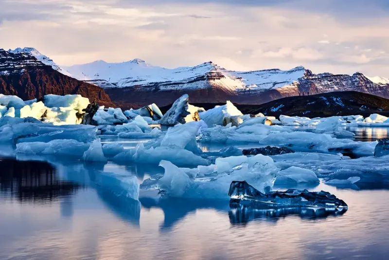 Jökulsárlón Glacier Lagoon with floating icebergs at golden hour, southeast Iceland